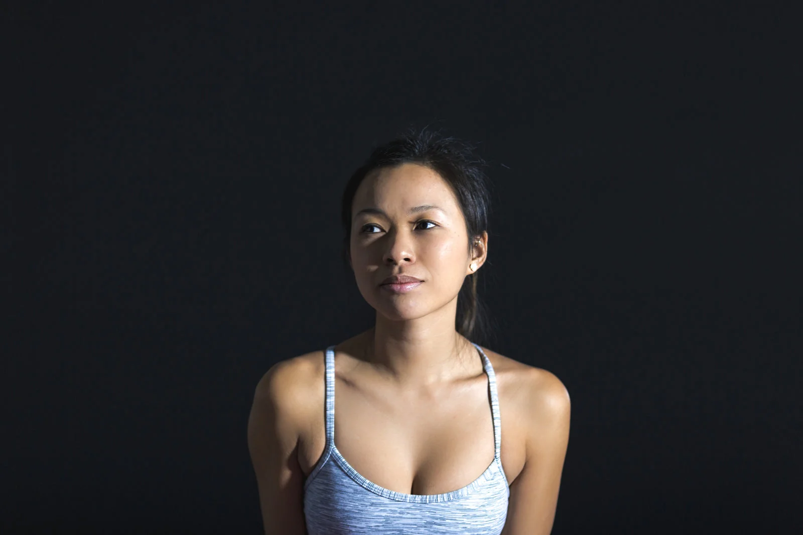 Portrait of a young woman against a dark background