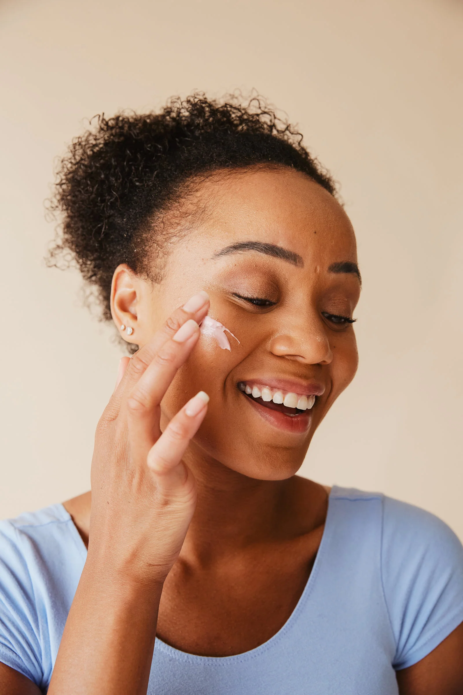 A smiling person with a face treatment on