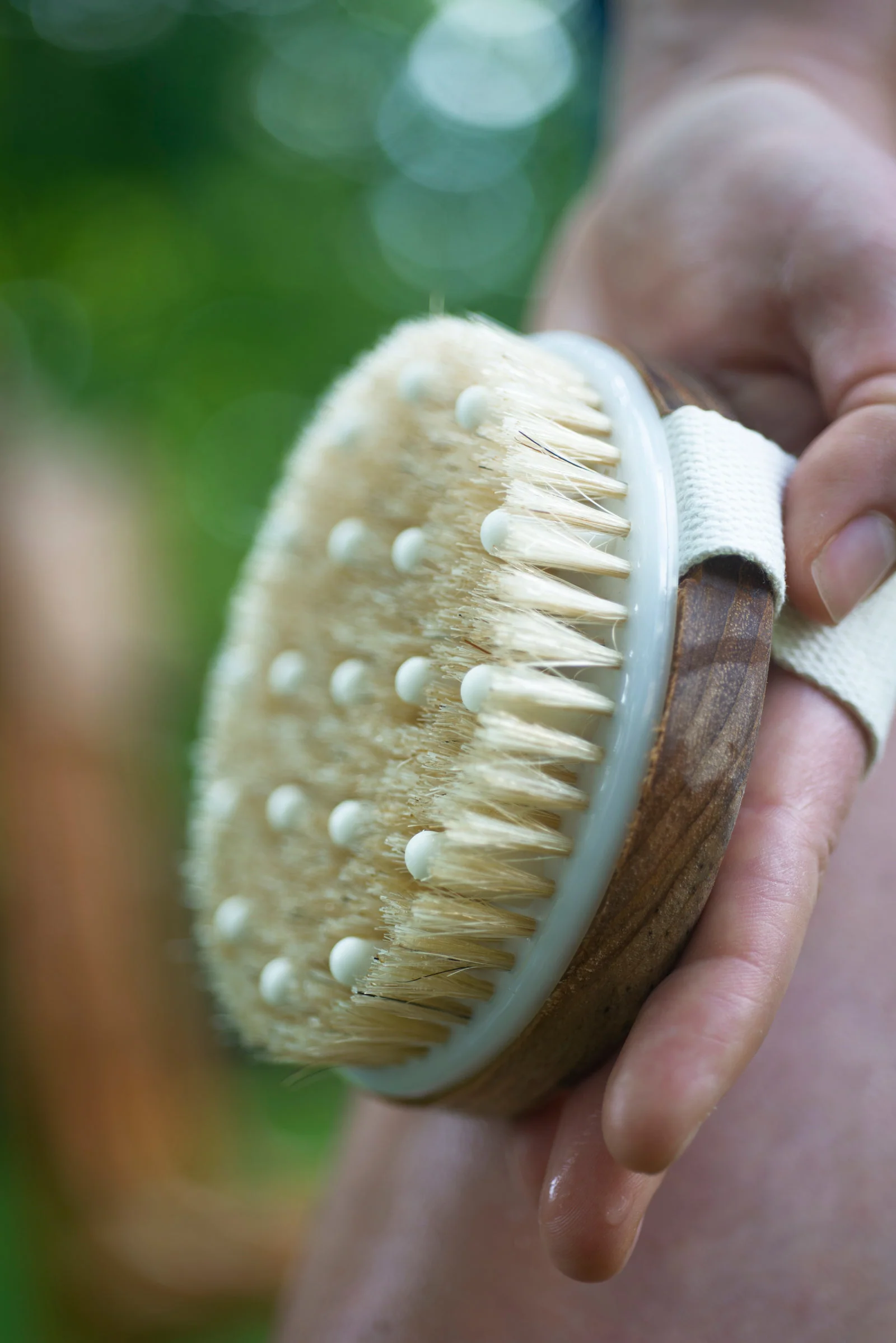A hand holding a skin tool towards the camera