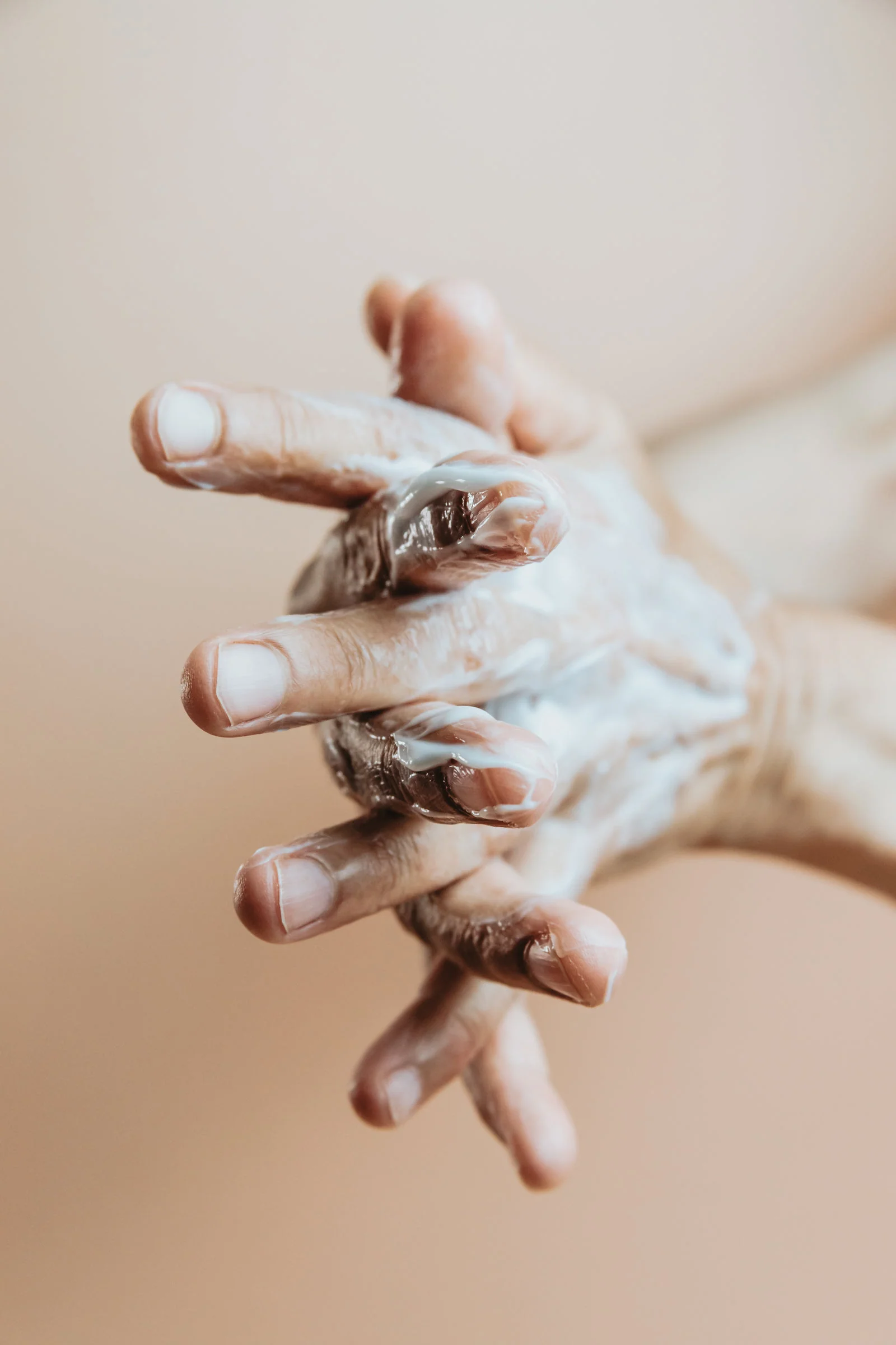 Hands working lotion into a lather